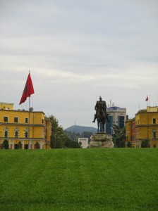The statue of Skanderbeg in the middle of the square. The Italian-inspired government buildings are in the background.