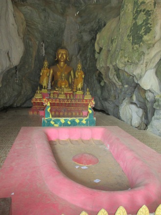 Buddha at entrance to cave